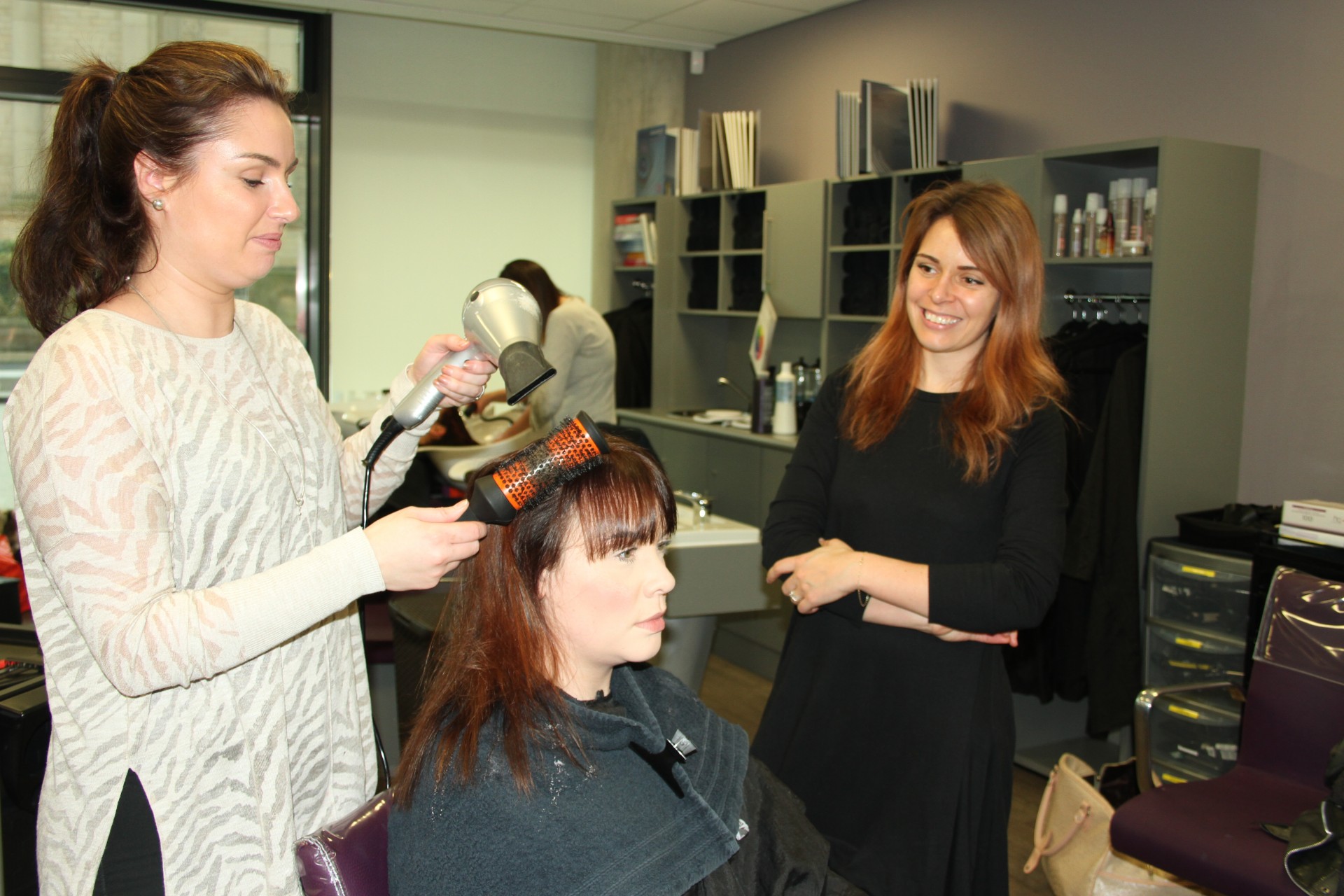 Chelsea Larkin of Precious Hair and Beauty Lounge styles her business partner and Natalie Dewhirst’s hair, watched by Amy Sontae of Wella.